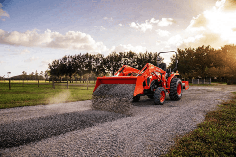 Tractor dumping gravel onto driveway