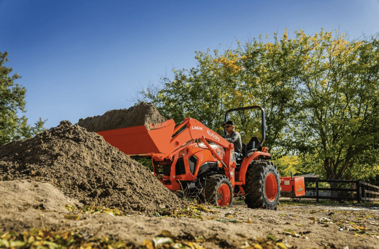 Tractor dumping dirt onto pile