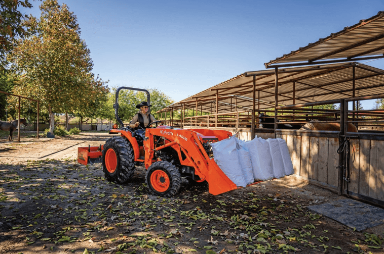 Tractor moving horse feed to stables
