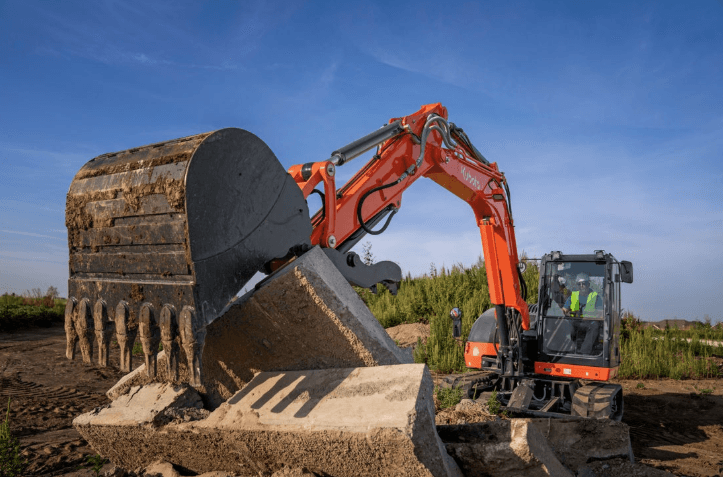Excavator moving cement slabs