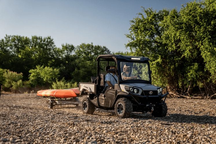 RTV hauling a trailer with a kayak 