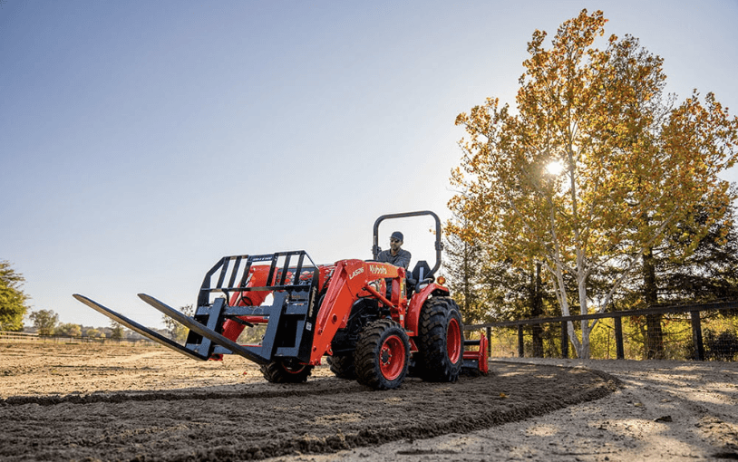 Man driving tractor with an attachment