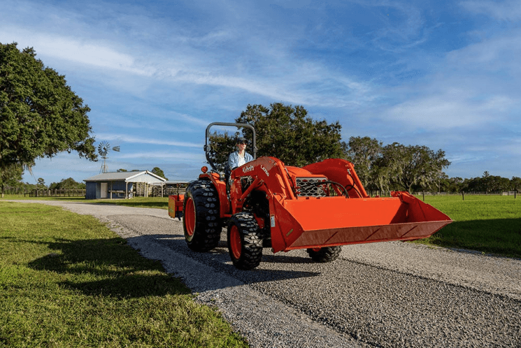 Tractor driving down gravel driveway