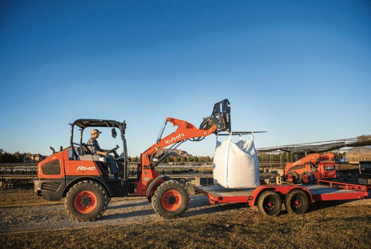 Wheel loader loading onto a trailer