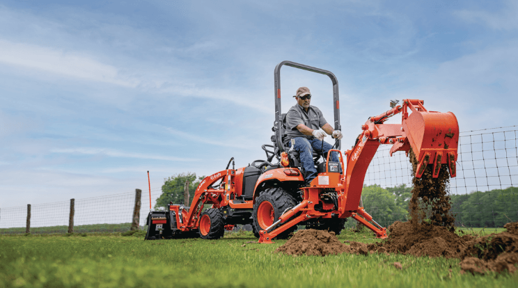 Man using back hoe implment